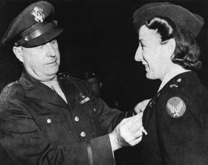 AVNURS, pho 1 Elsie Ott, who made the first air evacuation (?), was also the first to receive the Air Medal.  Shown in photo receiving the award from Brig Gen Fred W. Borum, who made the presentation at Bowman Field, KY, in 1943 (?). Credit Photo to the National Museum of the USAF